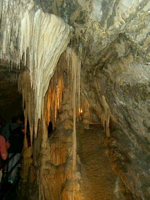 Two narrow passages lead off into the depths of the cave. One has been made available to visitors;the other, with its heavy overhang of dense grey rock, suggests a turtuous path to some marvellous destination.