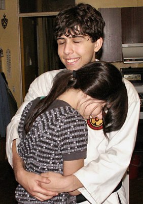 Alex getting a congratulatory hug from his sister.