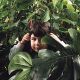 ...Jen peeping out from the big leaves of the pot plants...